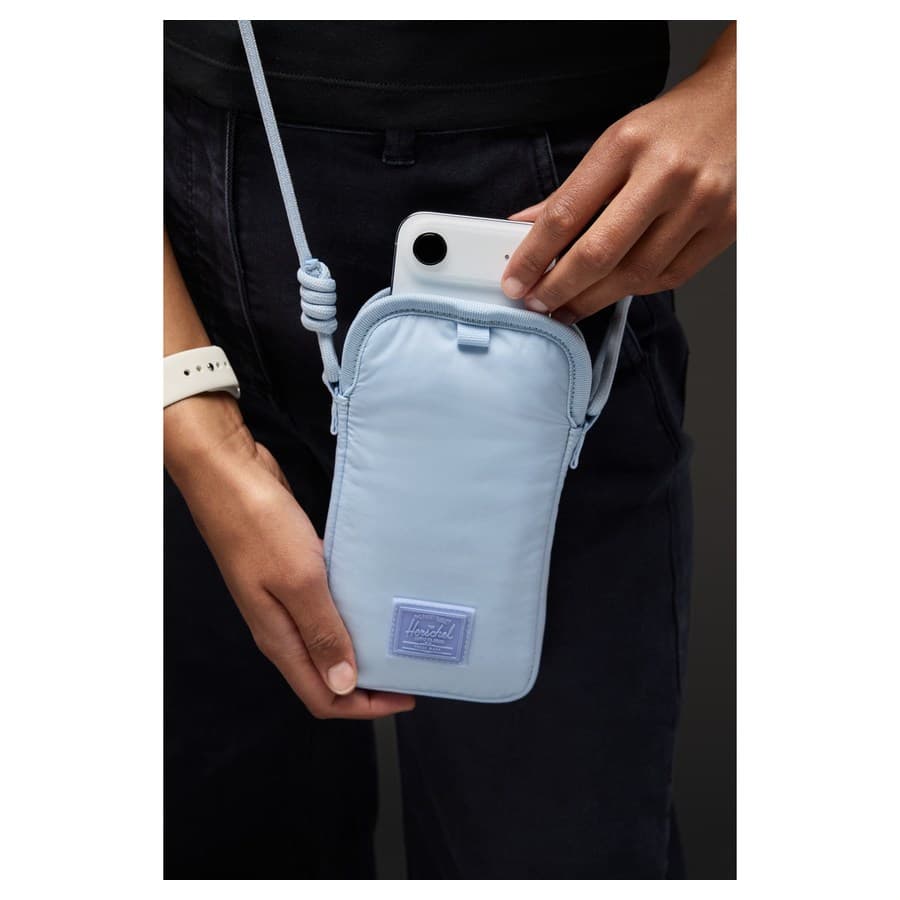 Herschel Cloudform Crossbody Bag for iPhone, blue color, adjustable twill webbing strap attached, hand removing iPhone f Apple sale