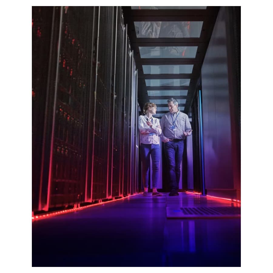 Woman and man walking through server room. Lenovo sale